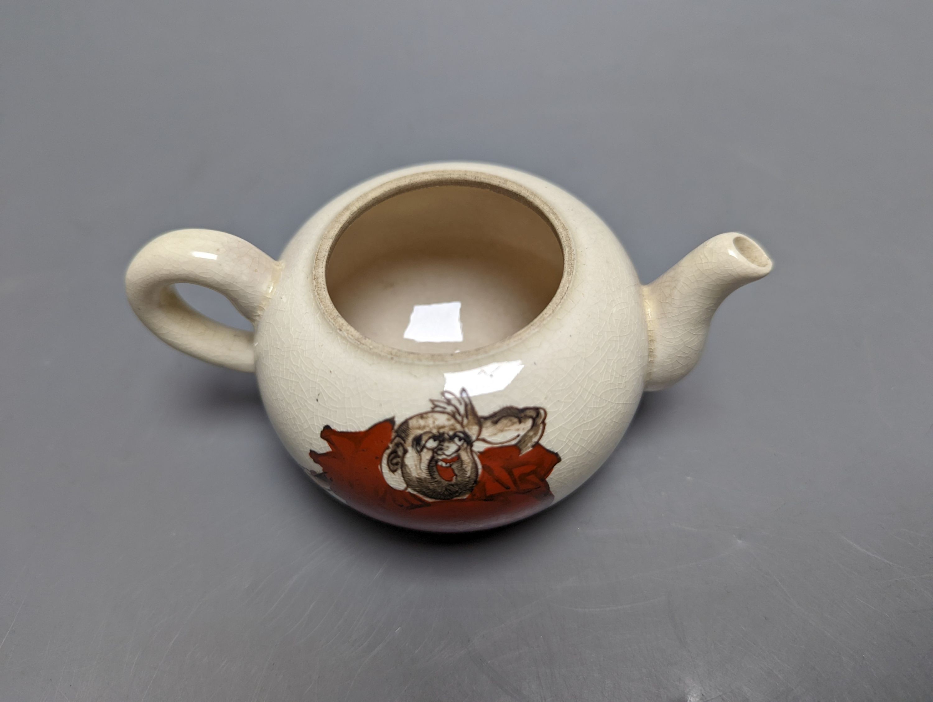 A Japanese pottery 'Daruma' teapot and pouring jug, circa 1900